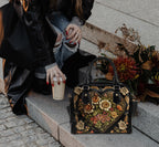 Vintage Victorian Bowler Bag by Fae & Magpie, showcasing a classic leather bag with ornate detailing and sturdy round handles.