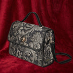 Decorative handbag with floral pattern on a red fabric background