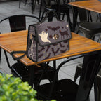 Fae & Magpie spooky satchel bag with gothic design, featuring dark patterns and a sturdy handle, perfect for Halloween or gothic fashion.