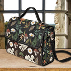 Floral and mushroom patterned handbag on a wooden surface with a window in the background