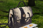 Black cat satchel bag by Fae & Magpie with a structured design, top handle, and adjustable shoulder strap on a white background.