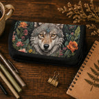 Small pouch with wolf design on a wooden surface with stationery items