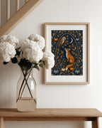 A framed art print featuring a whimsical fox and owl illustration in autumn colors, styled on a white paneled wall above a wooden console table with a vase of white flowers.