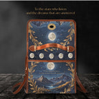 Decorative bag with celestial design featuring moon phases and mountains on a dark background.