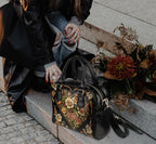 Vintage Victorian-style bowler bag by Fae & Magpie with leather handles and detailed stitching, shown in a close-up view.