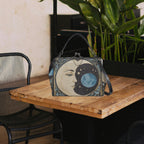 Fae & Magpie Blue Moon vintage handbag with textured leather and elegant design, featuring a top handle and gold-tone hardware.