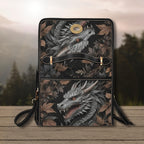 Handbag with dragon design on a wooden surface with a blurred natural background