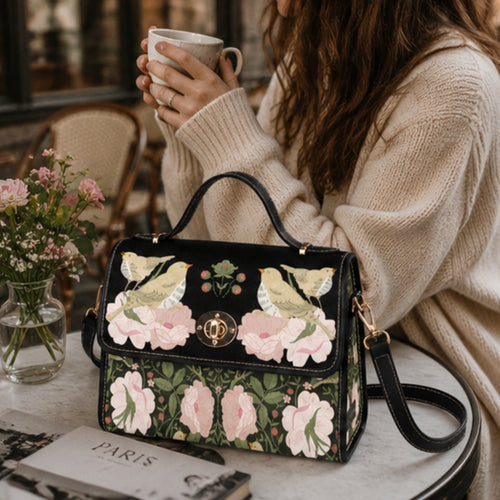 Woman holding a floral handbag with a cup of coffee in a cozy setting