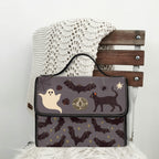 Fae & Magpie Spooky Satchel Bag featuring a dark, whimsical design with a sturdy handle and spacious interior for everyday use.