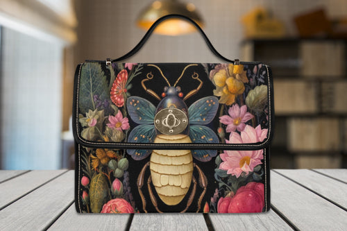 Fae & Magpie Bee Satchel Handbag with woven design, top handle, and adjustable strap, showcasing a stylish and functional accessory.