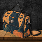Halloween-themed handbag with a black cat, pumpkins, and bats on an orange background.