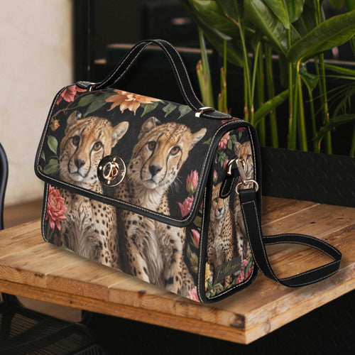 Fae & Magpie cheetah print satchel handbag with top handle and adjustable shoulder strap, featuring a stylish animal print design.