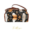 Handbag with bird and floral design on a black background, featuring the brand 'Fae & Magpie'.