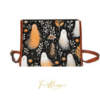 Handbag with ghost illustrations on a black background, featuring the brand 'Fae & Magpie'.