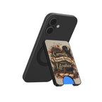 A black phone case with an integrated kickstand, shown from two angles. The back view shows a matte black finish with a circular MagSafe ring.