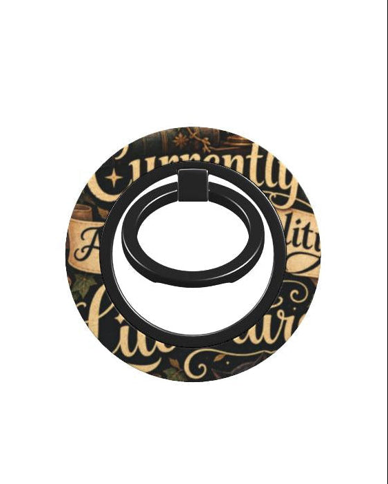 A circular black ring holder featuring a decorative gold and black script pattern, shown against a plain white background.