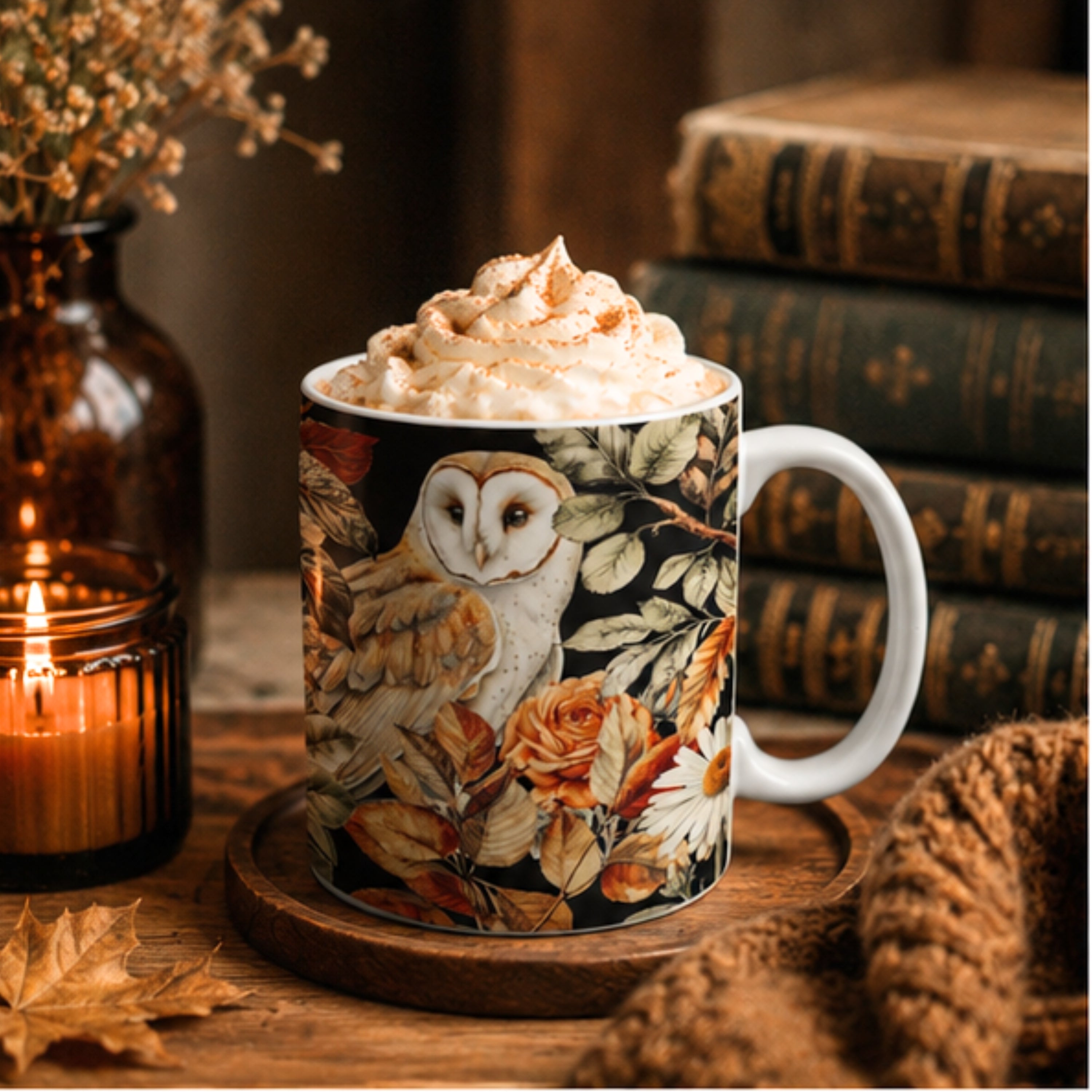 Mug with owl design filled with hot chocolate and whipped cream, surrounded by books and a candle.