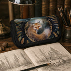 Pencil case with fox design on a wooden table with a notebook and pencils.
