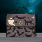 Fae & Magpie spooky satchel bag with dark floral pattern, leather accents, and adjustable strap, perfect for gothic style accessories.
