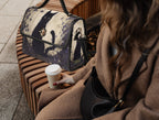 Black cat-shaped satchel bag by Fae & Magpie with a sleek black finish and adjustable strap, crafted for stylish everyday use.