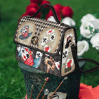 Handbag with playing card design on a decorative hat against a floral background