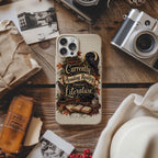 A phone case featuring a vintage-style illustration of a raven, books, and the quote 'Currently Avoiding Reality Through Literature' in a cozy autumn theme, displayed on a rustic wooden table surrounded by props like a camera, hat, and old papers.