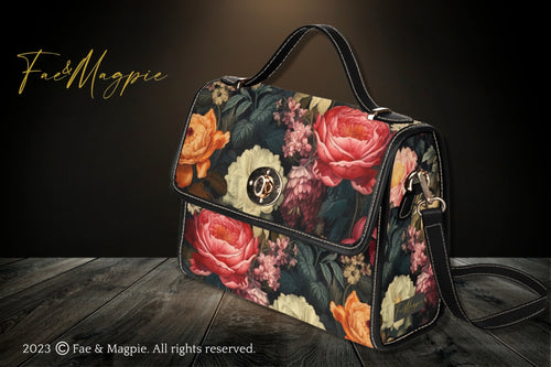 Fae & Magpie Botanical Satchel Bag with floral print, leather accents, and adjustable strap, displayed on a plain background.