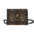 Handbag with celestial pattern featuring moons and stars on a black background
