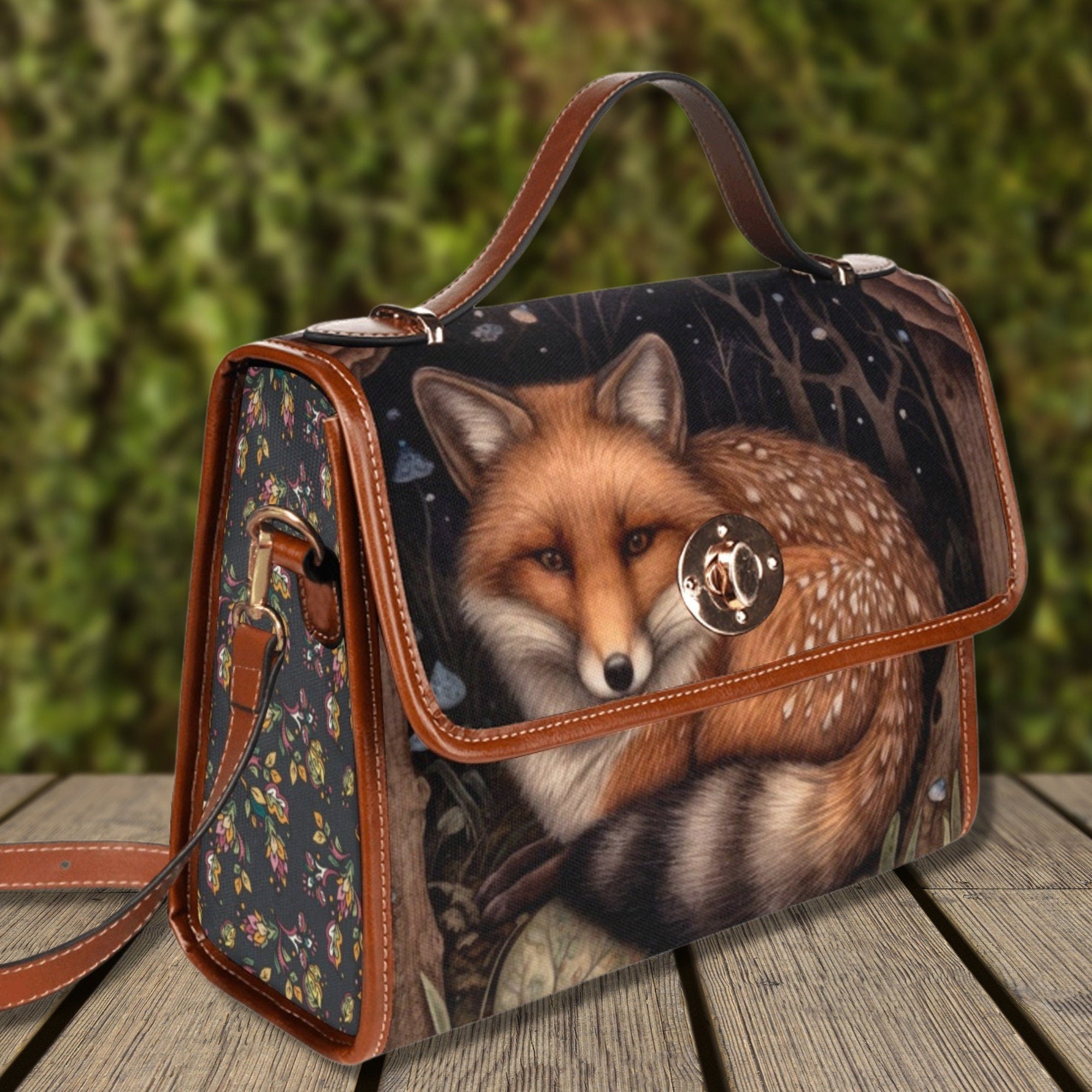 Handbag with a fox design on a wooden surface with a blurred green background