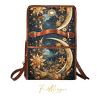 Fae & Magpie Celestial Dreams satchel handbag with star and moon pattern, leather strap and gold-tone hardware, stylish and elegant.