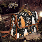 A structured tote bag with a black background and a whimsical ghost pattern, styled in a moody, rustic setting with ferns, a lantern, and books.