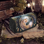 Cosmetic bag with fox design on a rustic background with books and plants