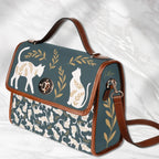 White Fae & Magpie cats satchel handbag with structured design and top handle, featuring a charming feline motif.