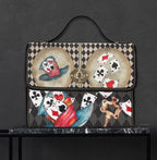 Handbag with playing card design on a dark background