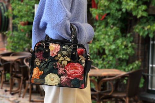Fae & Magpie botanical floral bowler bag with colorful floral pattern and sturdy leather handles on a plain background.