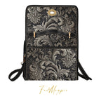Floral patterned handbag with black strap on a white background, featuring the brand 'Folk Magpie'.