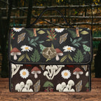 Floral and mushroom patterned bag on a wooden surface with a natural background
