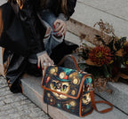 Person holding a handbag with a cat design on a stone step